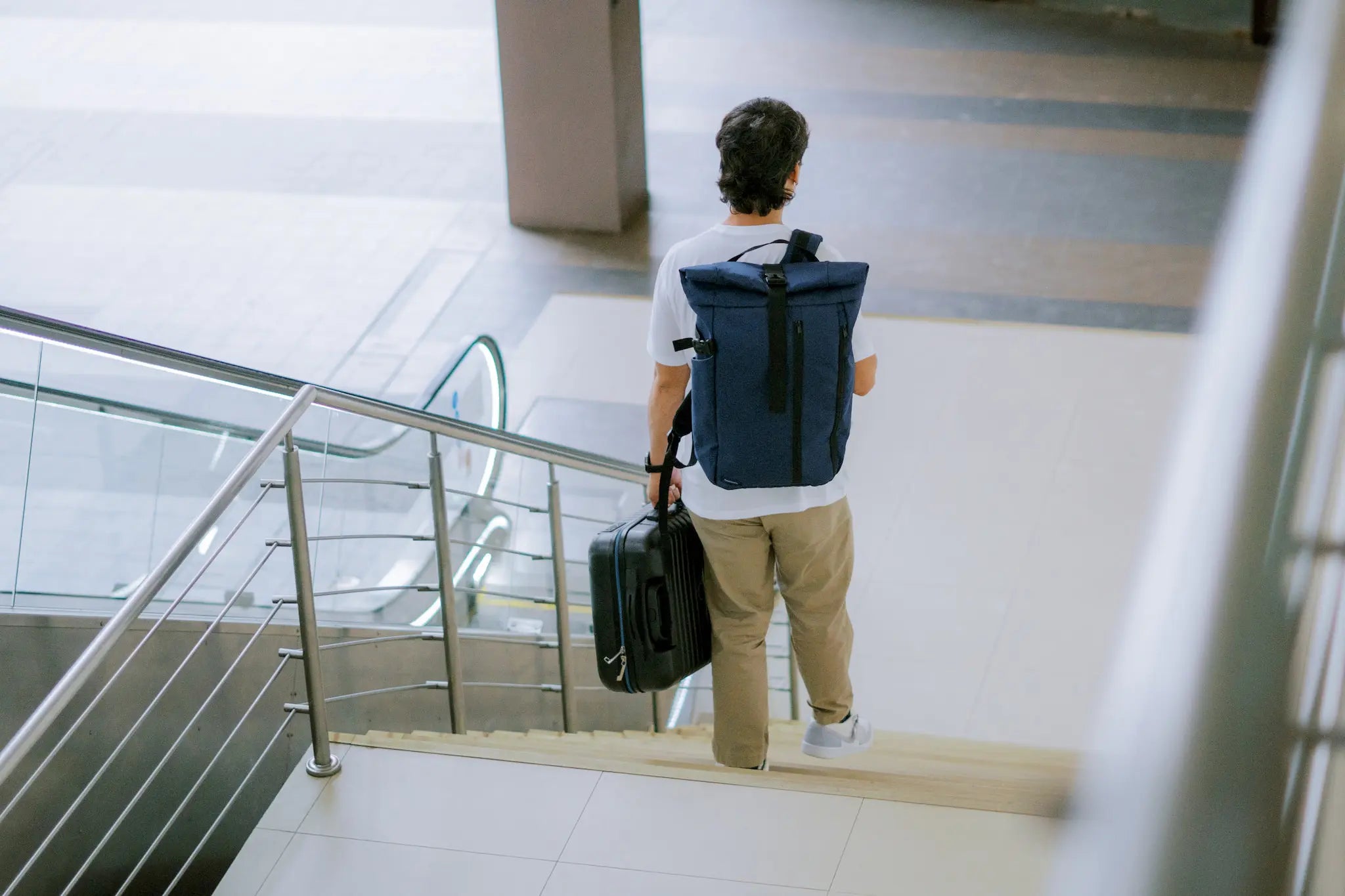 Man commuting with Frost & Frost Co. water-resistant backpack and travel bag